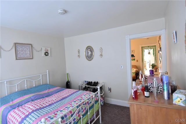 carpeted bedroom featuring baseboards