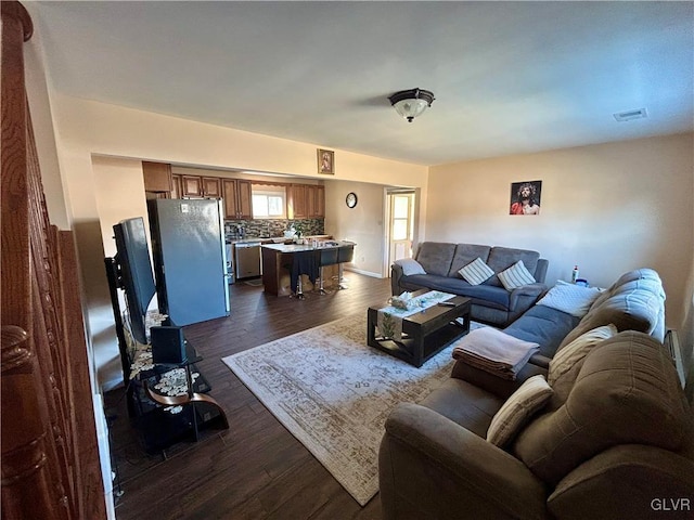 living room with visible vents and dark wood-type flooring