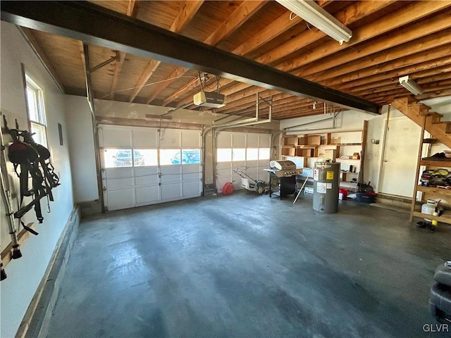 garage with water heater and a garage door opener