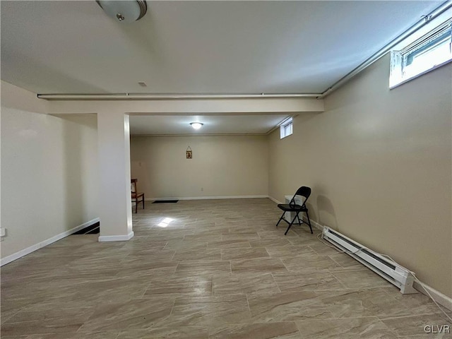 below grade area featuring baseboards and a baseboard heating unit