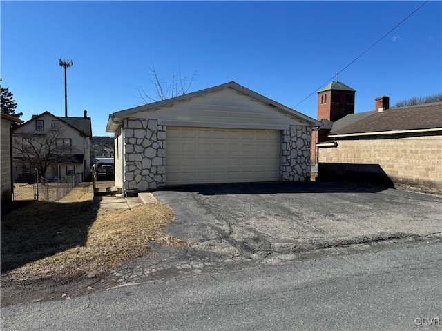 detached garage featuring fence