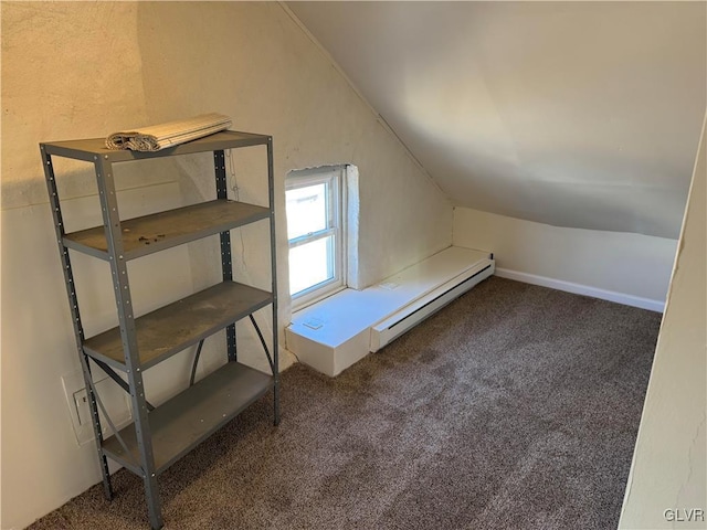 bonus room with a baseboard heating unit, lofted ceiling, and carpet flooring