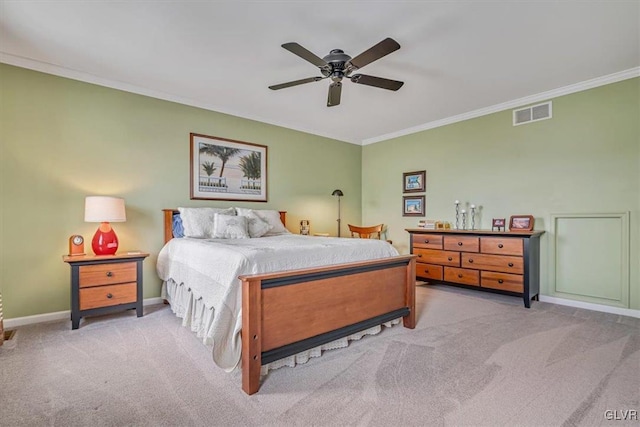 carpeted bedroom featuring baseboards, visible vents, ceiling fan, and crown molding