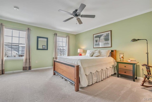 carpeted bedroom with baseboards, ornamental molding, and a ceiling fan