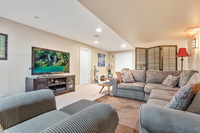 living area with carpet, visible vents, and recessed lighting