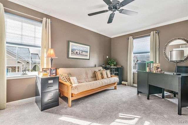 interior space with baseboards, carpet flooring, a ceiling fan, and crown molding