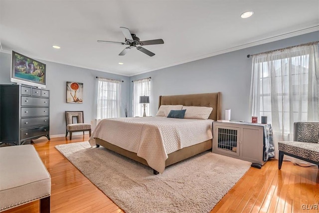 bedroom with baseboards, a ceiling fan, ornamental molding, light wood-type flooring, and recessed lighting