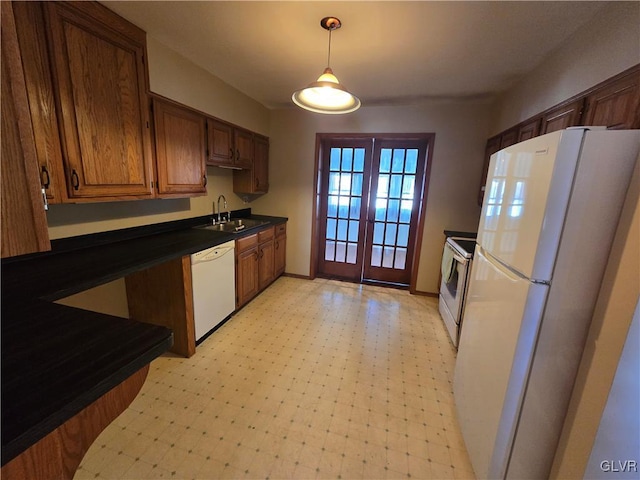 kitchen with white appliances, light floors, a sink, french doors, and dark countertops