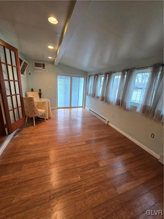 interior space featuring wood finished floors, recessed lighting, baseboards, baseboard heating, and vaulted ceiling with beams