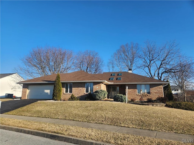 ranch-style house with aphalt driveway, brick siding, a garage, and a front lawn