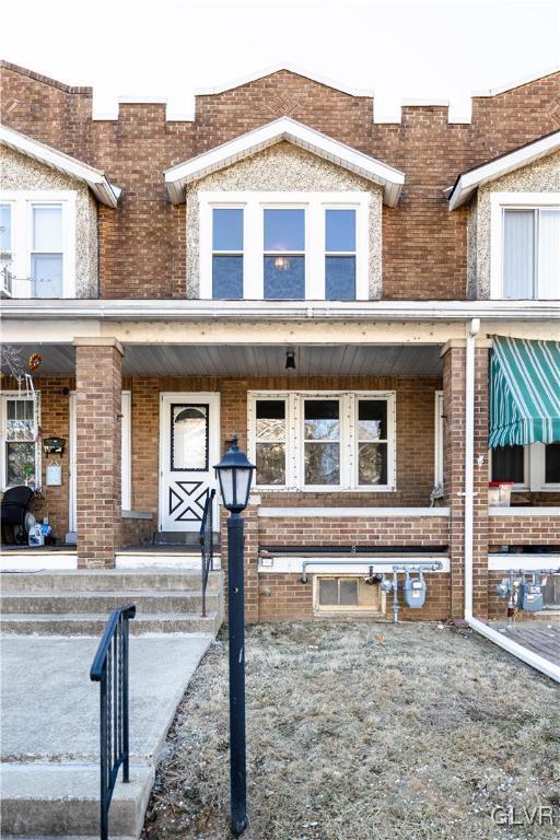 view of front of home featuring brick siding