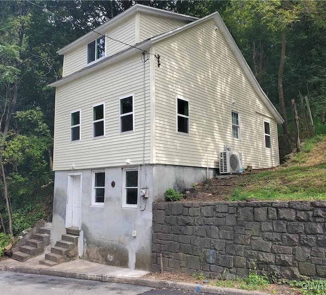 view of front facade featuring entry steps and ac unit