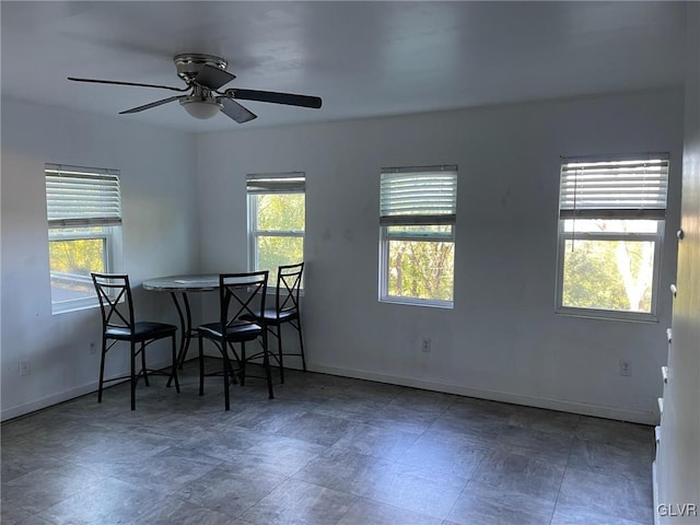 dining space featuring baseboards and plenty of natural light