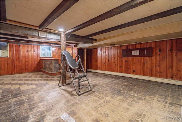 basement featuring tile patterned floors and wood walls