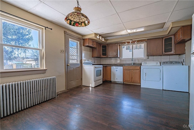 kitchen with dark wood-type flooring, radiator heating unit, decorative backsplash, independent washer and dryer, and white appliances