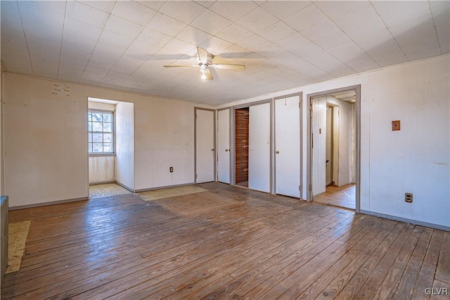 empty room with hardwood / wood-style floors and a ceiling fan