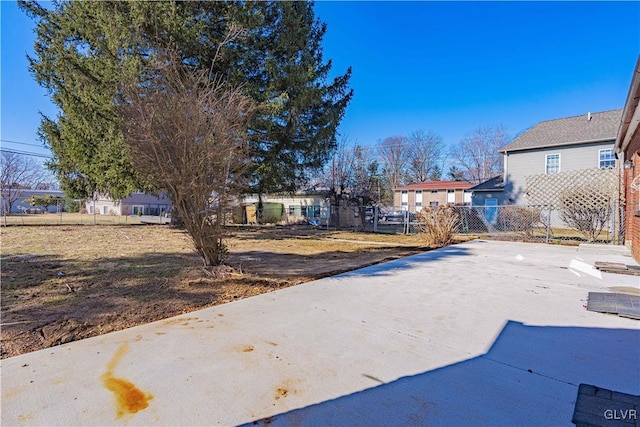 exterior space featuring a residential view and fence