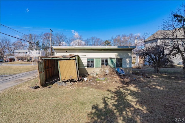 back of house with an outbuilding