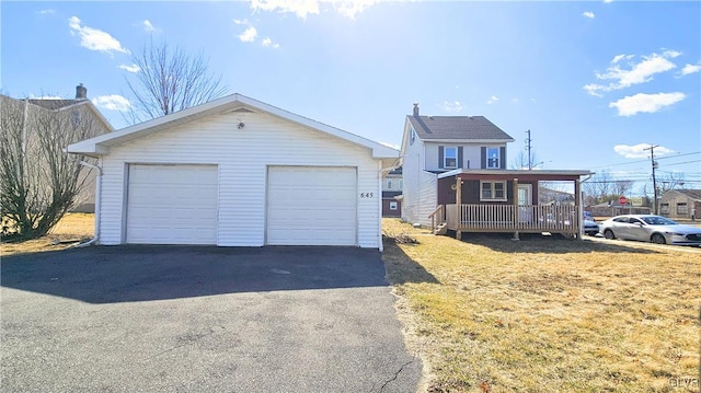 view of front of house featuring a detached garage and an outdoor structure