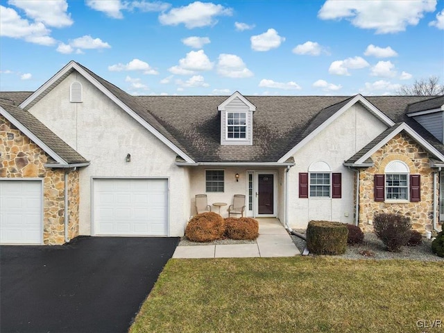 view of front of house with a front lawn, stucco siding, driveway, stone siding, and an attached garage