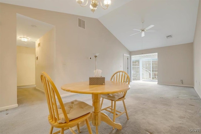 dining area with visible vents, light colored carpet, ceiling fan with notable chandelier, and high vaulted ceiling