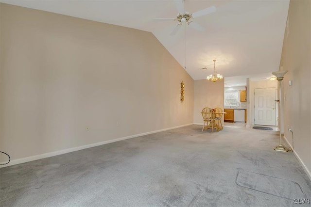 unfurnished living room with ceiling fan with notable chandelier, lofted ceiling, light colored carpet, and baseboards