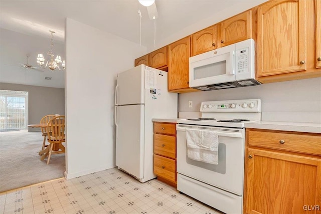 kitchen with white appliances, light floors, baseboards, light countertops, and a notable chandelier