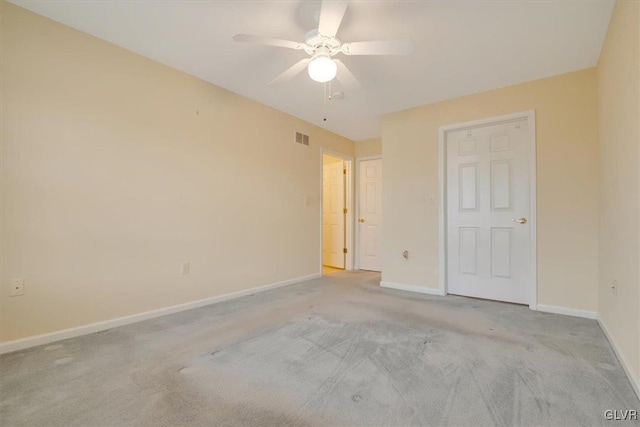 unfurnished bedroom featuring a ceiling fan, baseboards, visible vents, and carpet floors