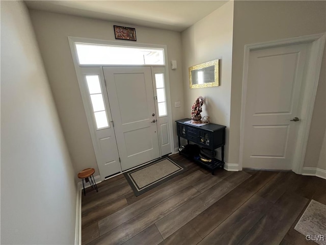 entryway featuring baseboards and dark wood-style flooring