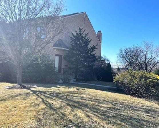 view of property exterior with a lawn