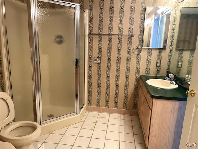 full bathroom with toilet, a stall shower, tile patterned flooring, wallpapered walls, and vanity