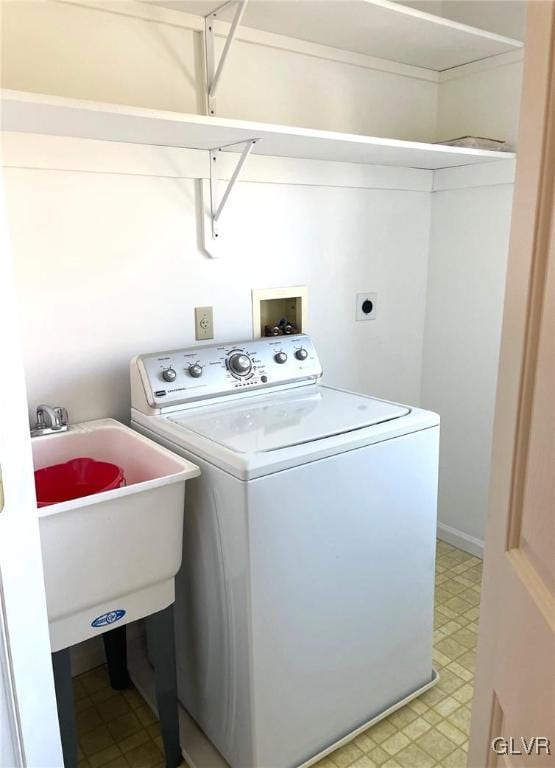 laundry area featuring laundry area, washer / clothes dryer, light floors, and a sink