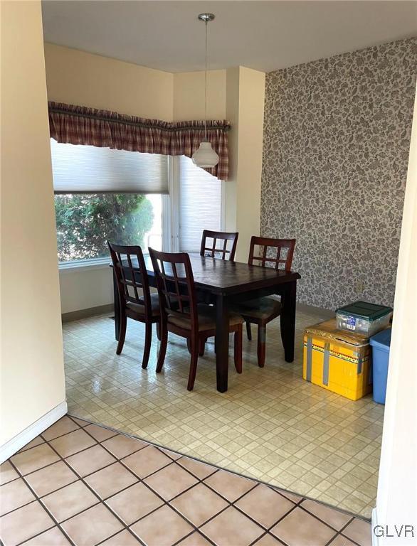 dining area featuring baseboards