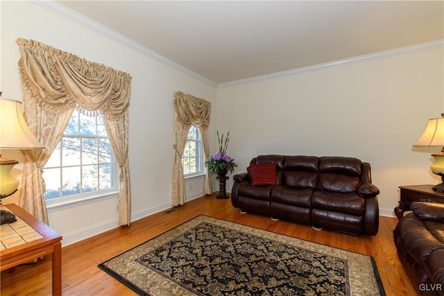 living room with visible vents, baseboards, wood finished floors, and crown molding