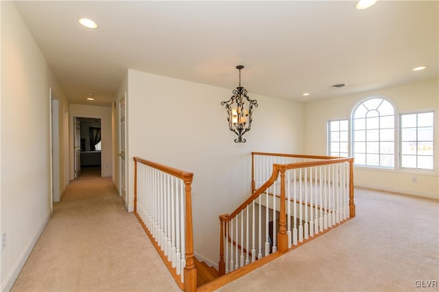 corridor with recessed lighting, an upstairs landing, baseboards, and light carpet