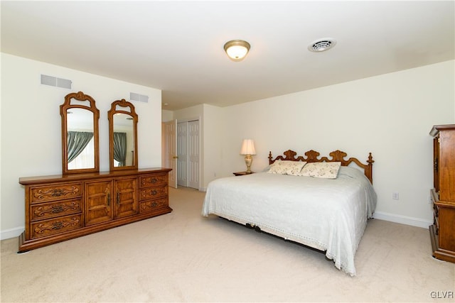 bedroom featuring light carpet, visible vents, and a closet