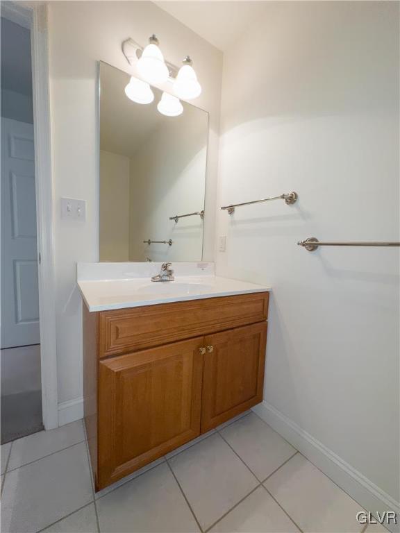 bathroom featuring baseboards, vanity, and tile patterned flooring