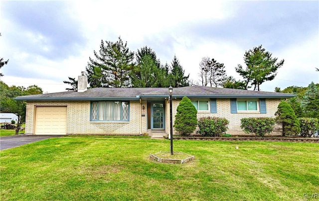 ranch-style home with brick siding, a front lawn, aphalt driveway, a chimney, and a garage