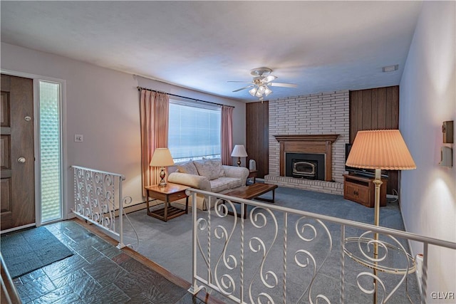 carpeted living room featuring ceiling fan and a fireplace