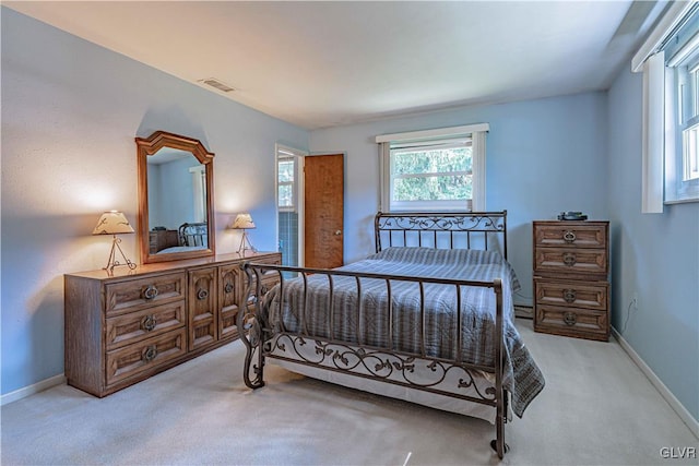 carpeted bedroom with visible vents and baseboards