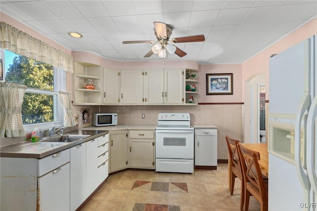 kitchen with a sink, white cabinets, white appliances, and open shelves