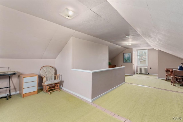 bonus room with lofted ceiling, radiator, carpet, and baseboards