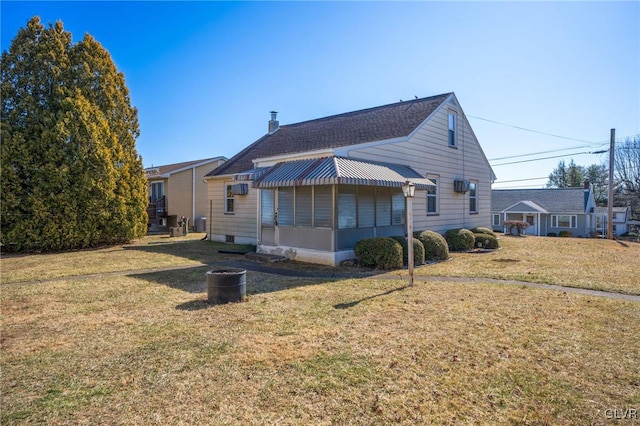 back of property featuring a yard