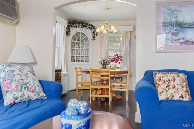 dining room featuring a chandelier, an AC wall unit, and wood finished floors