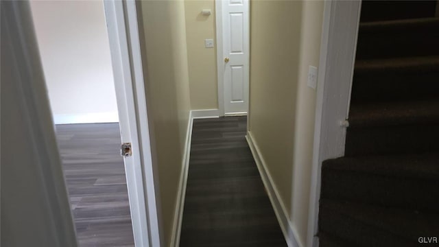 hall with baseboards and dark wood-style flooring