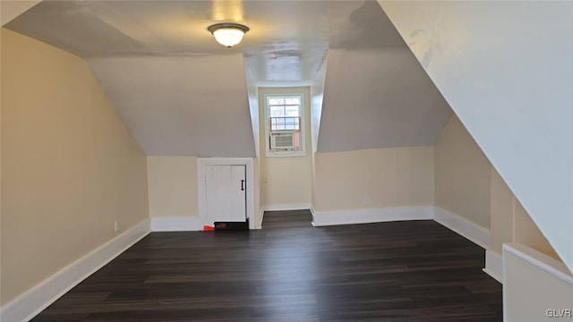 bonus room featuring vaulted ceiling, baseboards, and dark wood-style flooring