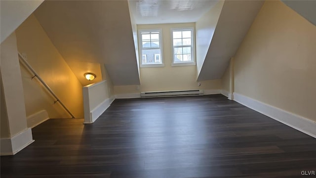 bonus room featuring dark wood finished floors, baseboard heating, and baseboards