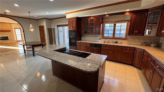 kitchen featuring light tile patterned floors, a kitchen island, black appliances, and tasteful backsplash