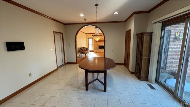 dining room with visible vents, light tile patterned floors, baseboards, and arched walkways