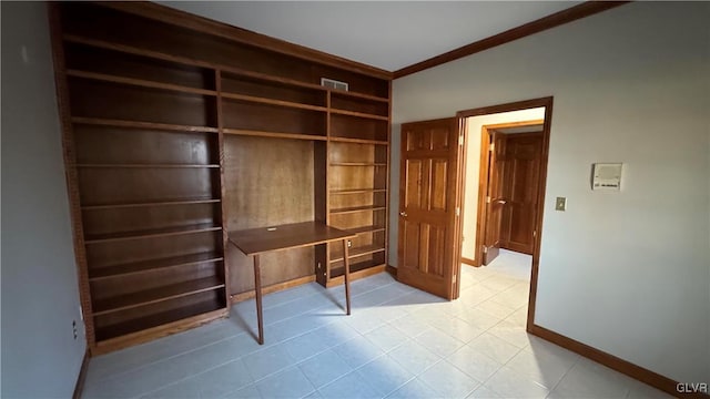 unfurnished office with baseboards and crown molding